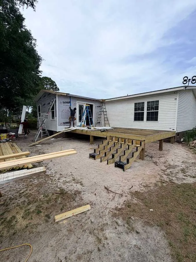 New deck framing alongside a home addition