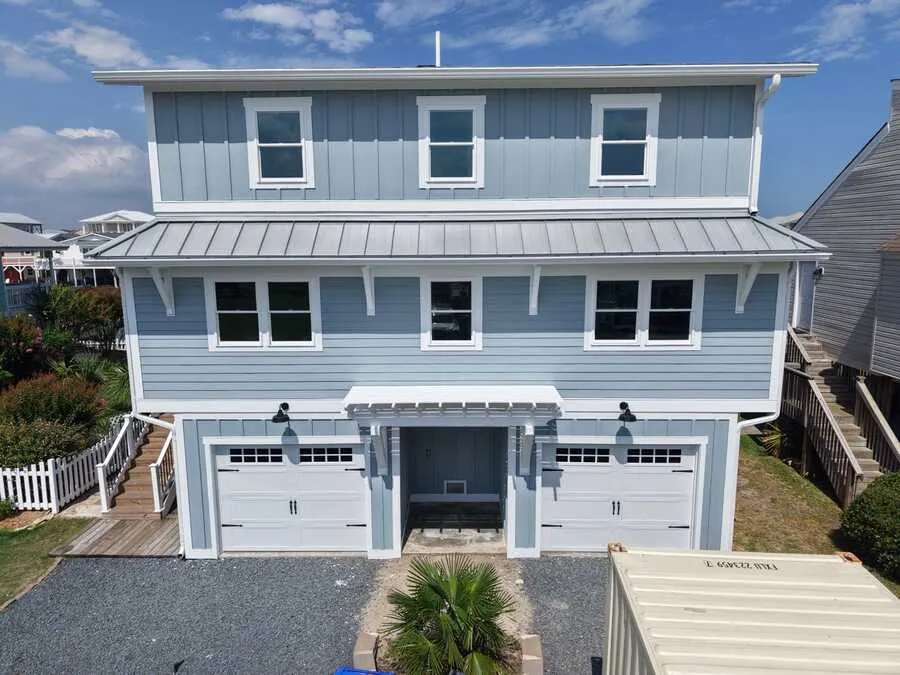 Two-story blue home with garage